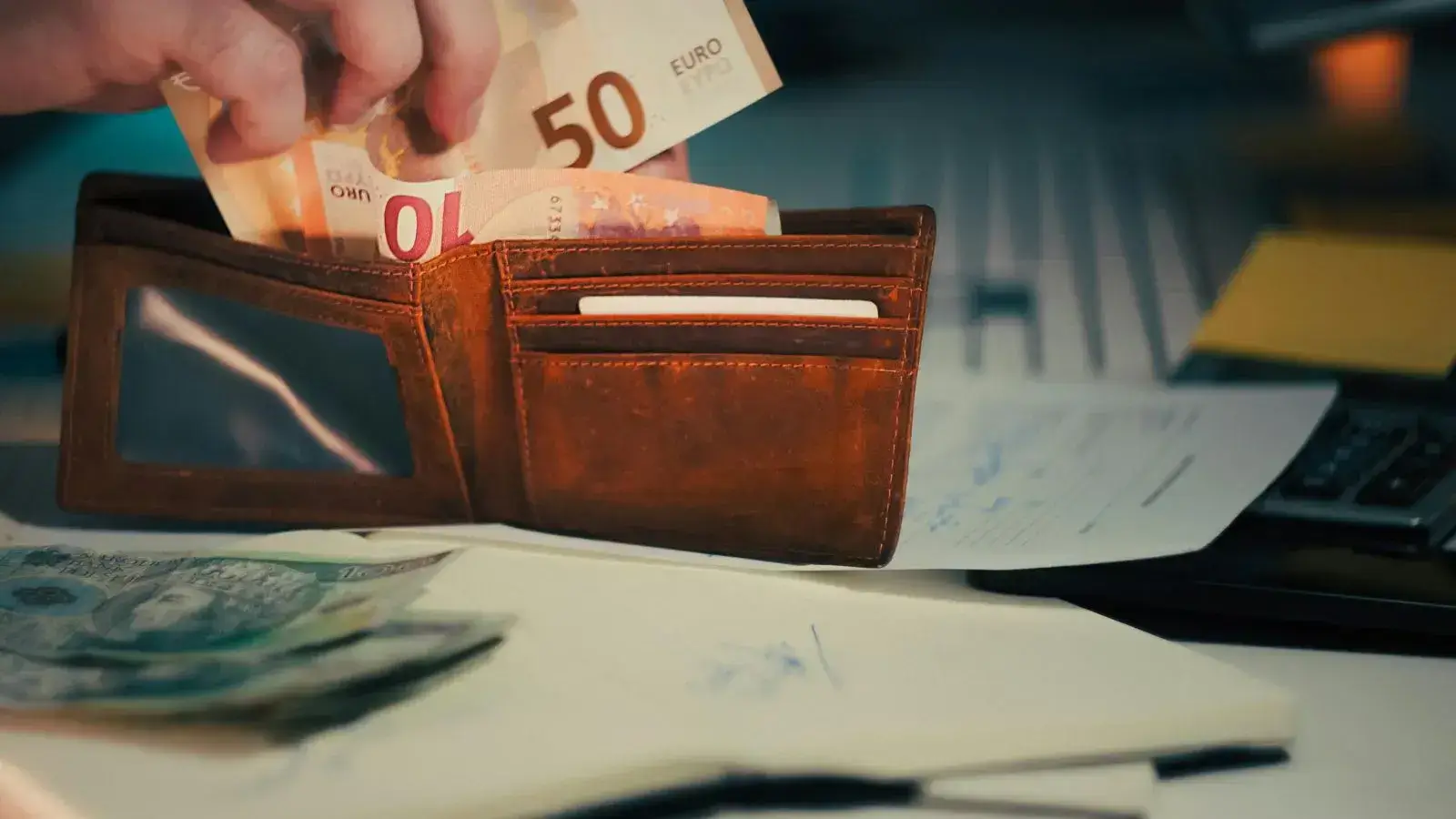 Monedero con monedas y billetes en euros, ilustrando el coste del seguro familiar en Alemania tras la reforma
